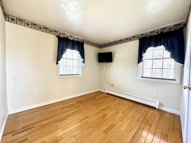 207 Blakely Farm Rd, Colebrook, NH 03576 - unfurnished room featuring wood finished floors, a baseboard heating unit, and baseboards