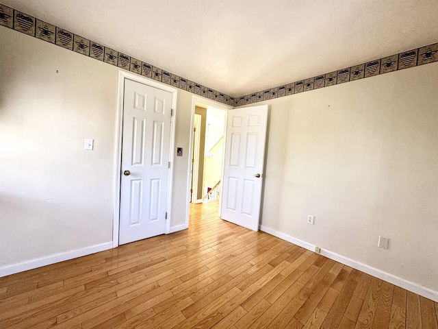 207 Blakely Farm Rd, Colebrook, NH 03576 - empty room with wood finished floors and baseboards