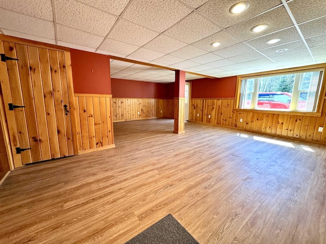 207 Blakely Farm Rd, Colebrook, NH 03576 - below grade area with wood walls, a wainscoted wall, baseboards, a drop ceiling, and wood finished floors