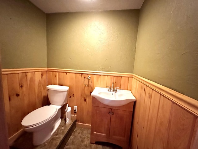 207 Blakely Farm Rd, Colebrook, NH 03576 - bathroom with toilet, a wainscoted wall, wood walls, and vanity