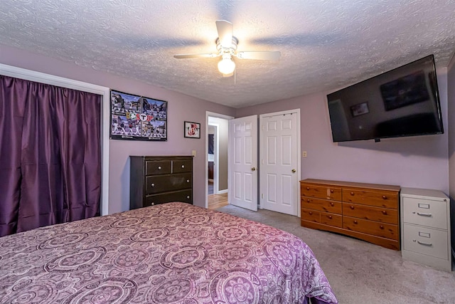 carpeted bedroom with a textured ceiling and ceiling fan