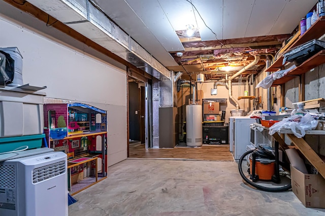 unfinished basement with washer / clothes dryer, water heater, and heating unit