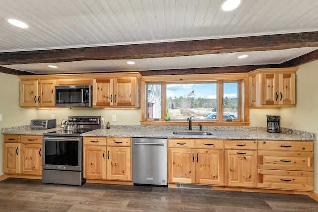kitchen with beamed ceiling, light brown cabinets, appliances with stainless steel finishes, and a sink