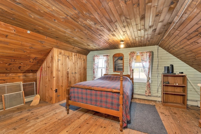 bedroom featuring lofted ceiling, wooden walls, hardwood / wood-style floors, and wooden ceiling