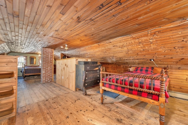 bedroom featuring lofted ceiling and light wood-style flooring