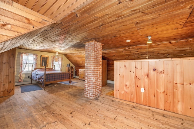 bedroom with wood walls, hardwood / wood-style flooring, wooden ceiling, and vaulted ceiling