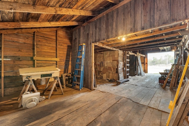 misc room with wood walls, hardwood / wood-style floors, vaulted ceiling with beams, and wood ceiling