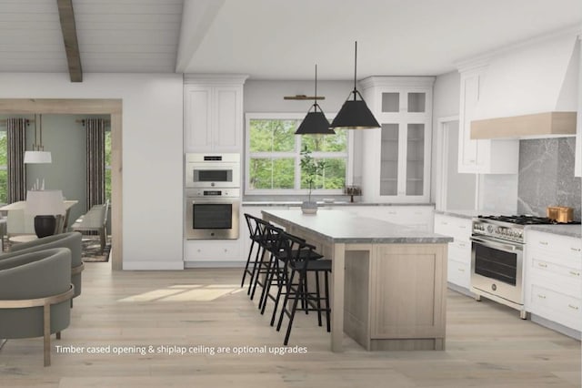 kitchen featuring a breakfast bar area, tasteful backsplash, stainless steel appliances, and plenty of natural light
