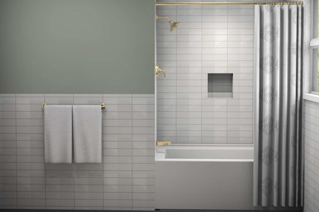 bathroom featuring shower / bathtub combination with curtain and tile walls