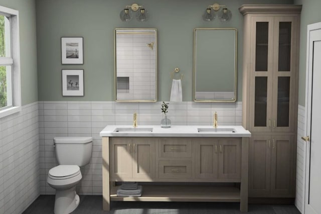 bathroom featuring toilet, a sink, and plenty of natural light