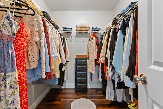 walk in closet with wood finished floors