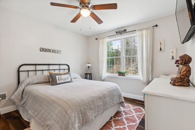bedroom with visible vents, ceiling fan, dark wood finished floors, and baseboards