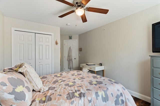 bedroom featuring a closet, dark wood-style flooring, ceiling fan, and baseboards