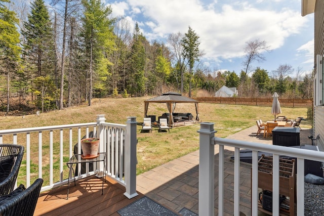 wooden deck featuring fence, a gazebo, a patio, outdoor lounge area, and a lawn
