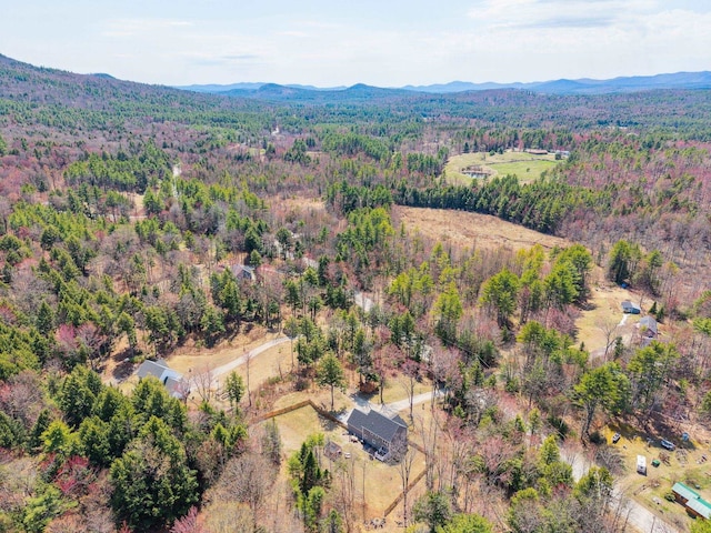 drone / aerial view with a mountain view and a view of trees
