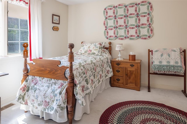carpeted bedroom featuring visible vents and baseboards