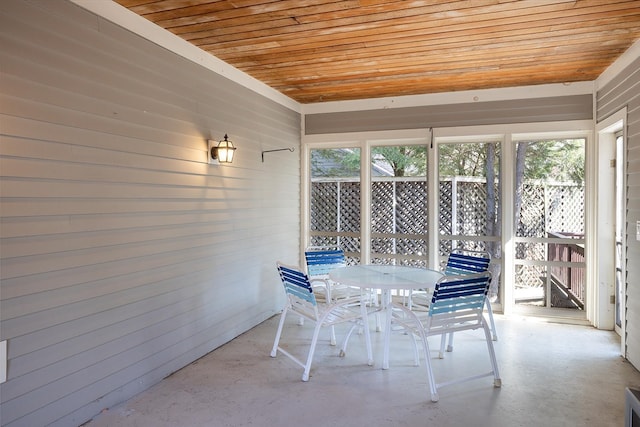 sunroom / solarium with outdoor dining area