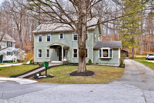 colonial home with a front lawn