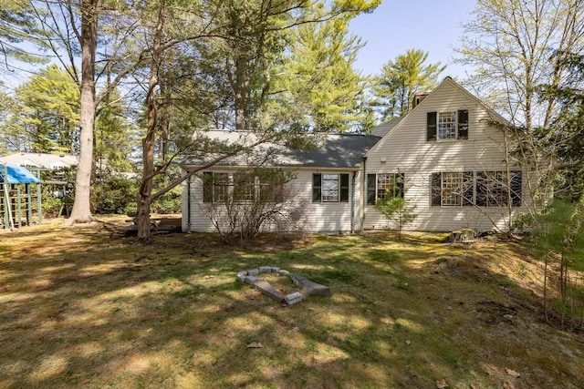 rear view of property with a yard