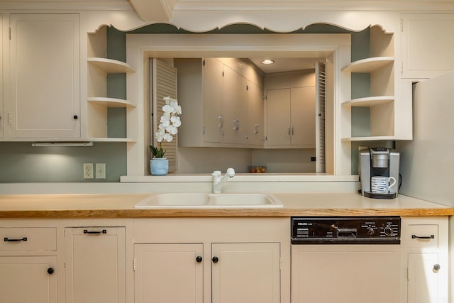 kitchen with a sink, open shelves, light countertops, dishwasher, and white cabinets