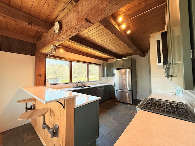 kitchen featuring wood ceiling, stone tile floors, stainless steel appliances, and a peninsula