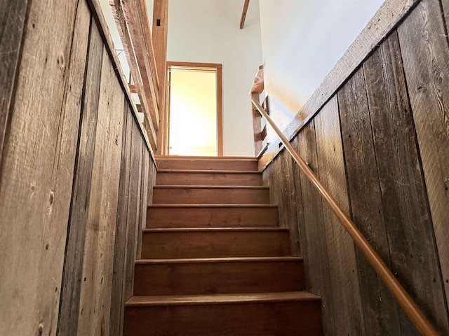 stairs with wood walls