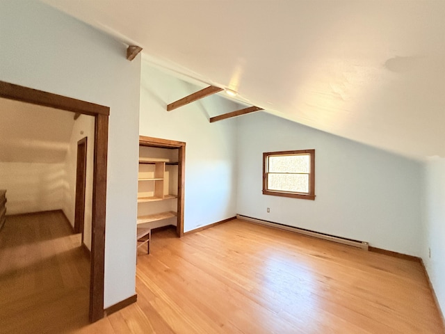 bonus room featuring lofted ceiling, light wood-style flooring, a baseboard heating unit, and baseboards