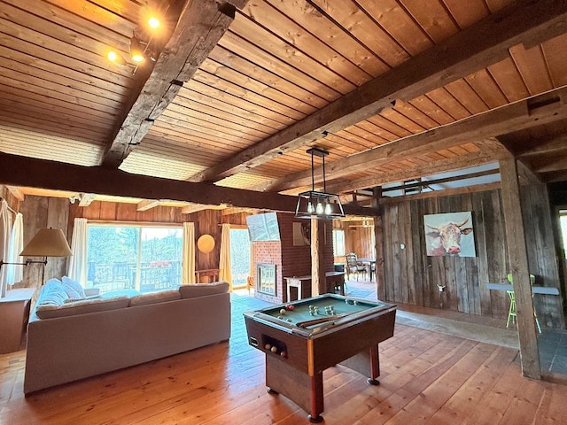 game room with beam ceiling, wooden walls, hardwood / wood-style floors, and pool table