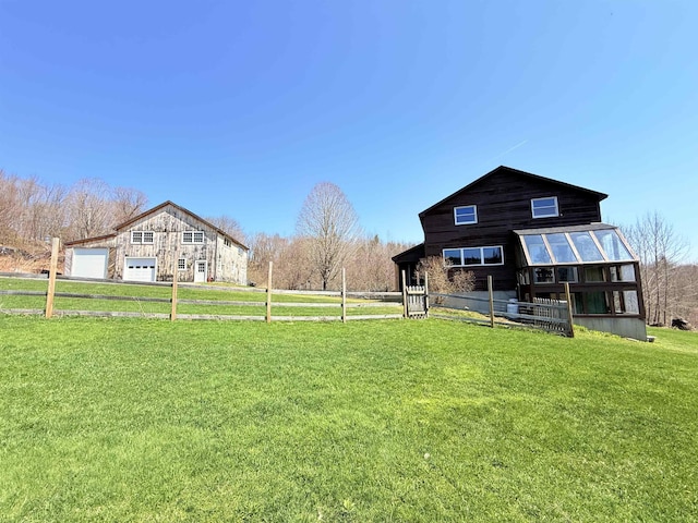 view of yard with fence and an outbuilding