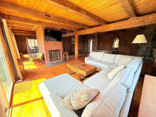 living area with wood walls, hardwood / wood-style flooring, and wood ceiling