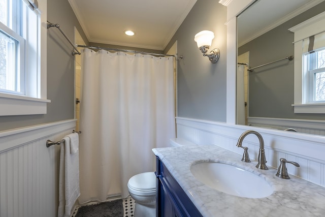 full bathroom featuring toilet, wainscoting, and ornamental molding