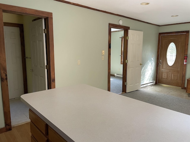 entrance foyer featuring ornamental molding and a baseboard radiator