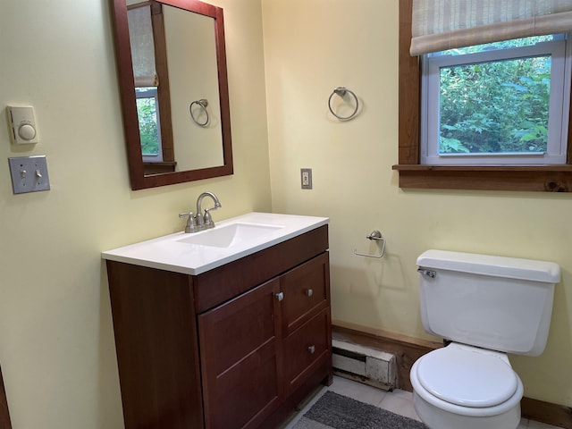 bathroom with toilet, baseboard heating, and vanity