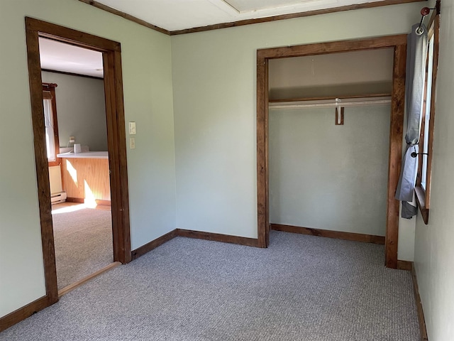 unfurnished bedroom with carpet, a closet, and baseboards