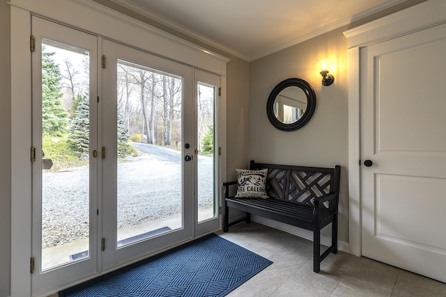 entryway featuring light tile patterned floors, a wealth of natural light, and ornamental molding