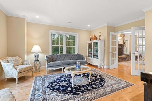 living area with ornamental molding, french doors, wood finished floors, and baseboards