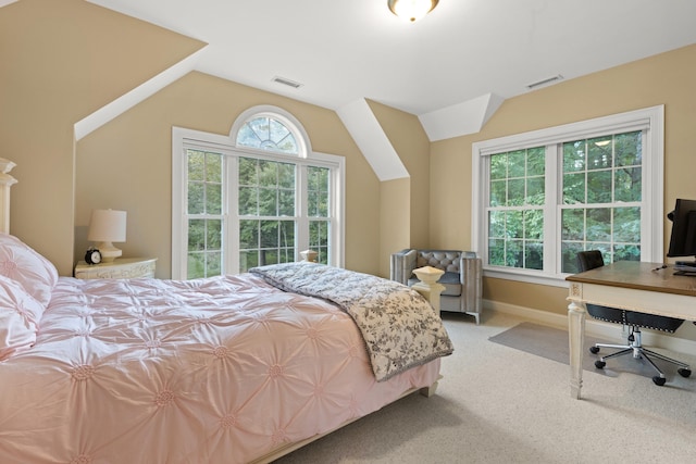 bedroom with carpet flooring, visible vents, vaulted ceiling, and baseboards