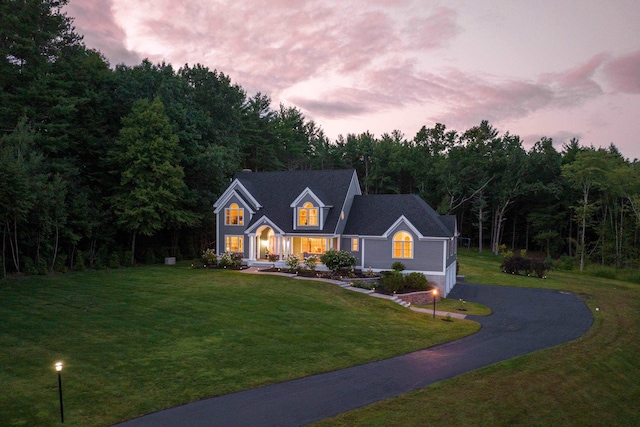traditional-style home featuring a front yard and driveway