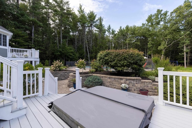 wooden terrace with a covered hot tub, fence, and a patio area