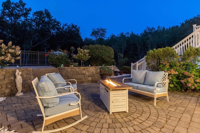 view of patio featuring an outdoor living space with a fire pit