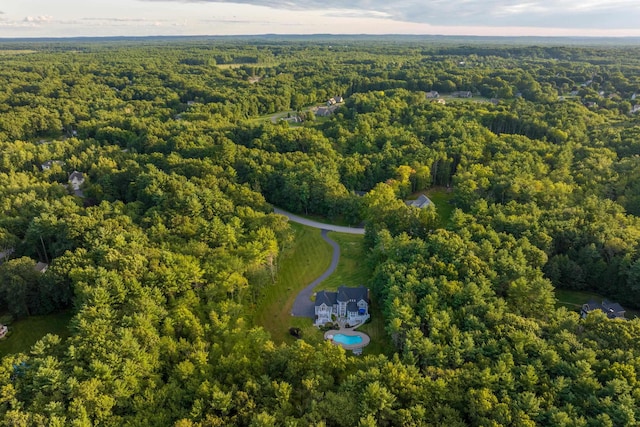 drone / aerial view with a wooded view