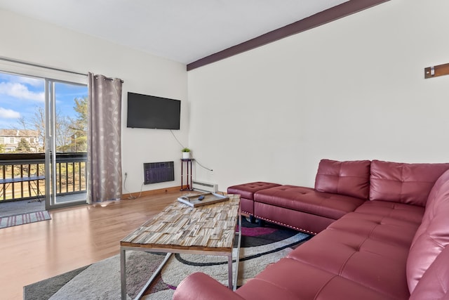 living room with baseboard heating, baseboards, and wood finished floors
