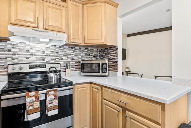 kitchen with decorative backsplash, light brown cabinets, light countertops, stainless steel appliances, and under cabinet range hood