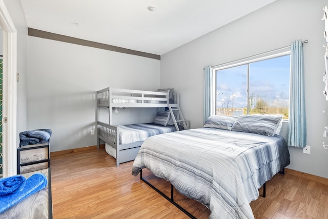 bedroom with wood finished floors and baseboards
