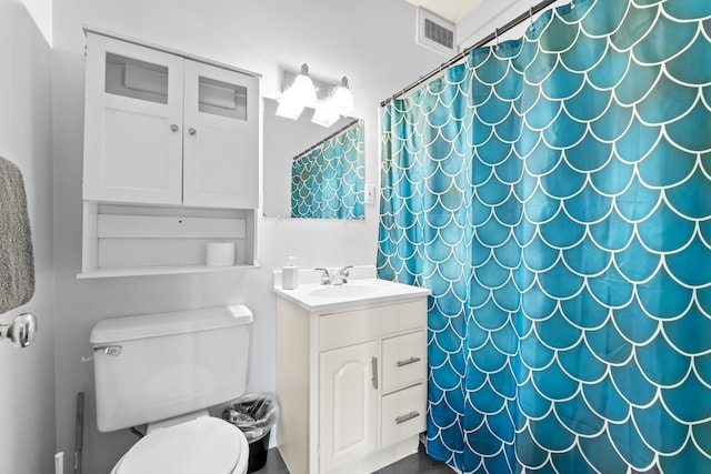 bathroom featuring curtained shower, visible vents, toilet, and vanity