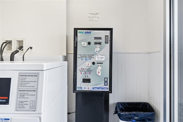 interior details with washer / clothes dryer and wainscoting