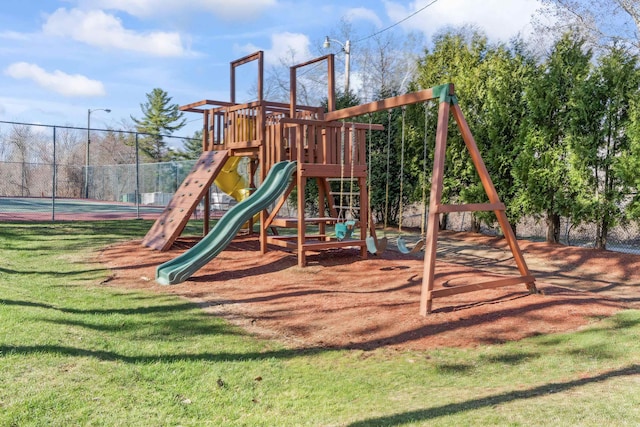 community playground featuring fence and a lawn