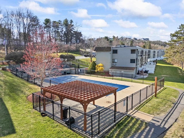 view of pool featuring fence and a lawn
