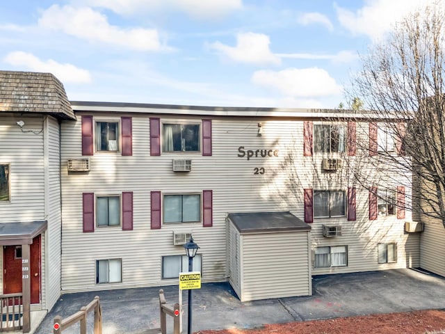 view of property featuring a wall mounted air conditioner