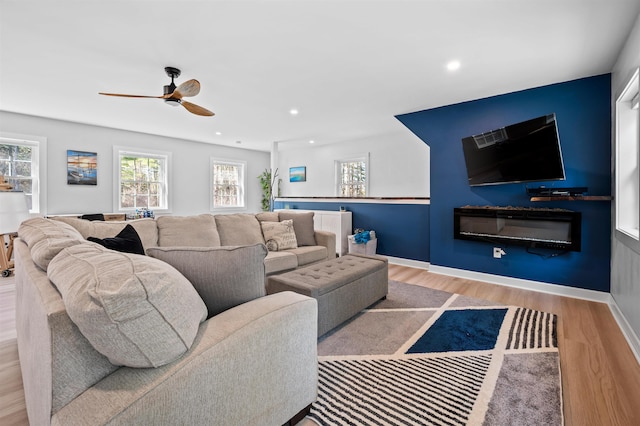 living room featuring recessed lighting, ceiling fan, and wood finished floors